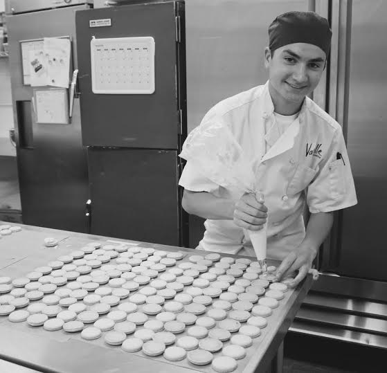 Danny Sickle fills macarons as he works in the kitchen of Vanille.