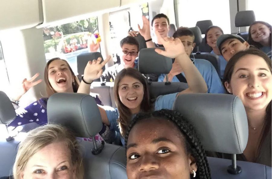 Students take a selfie while on the bus.