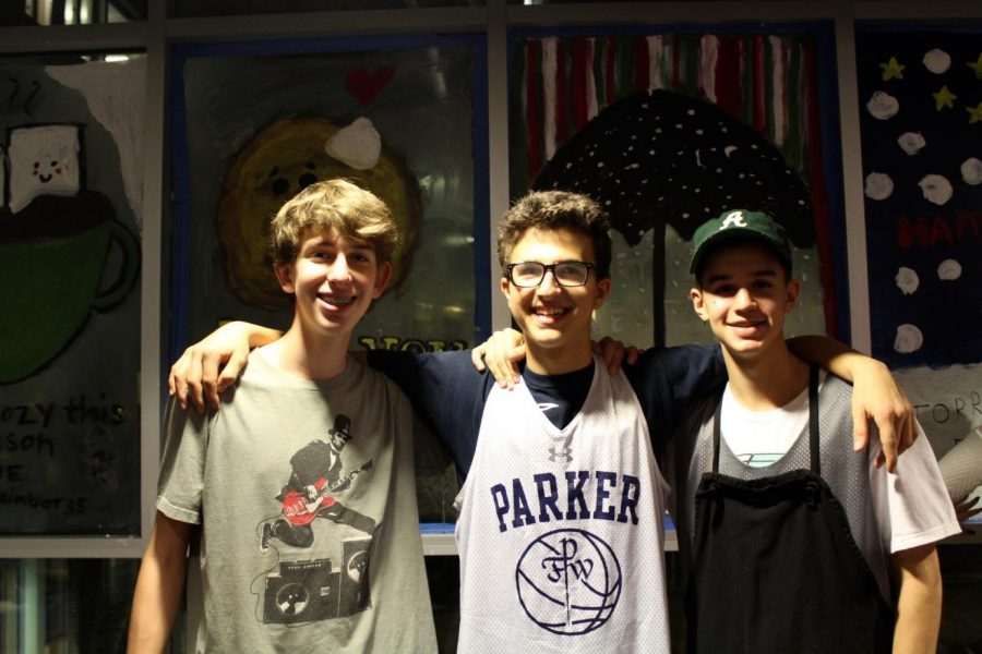 Freshmen (from left to right) Aidan Weinberg, Alex Schapiro, and Griffin Kass, all of whom are new to Parker this year, pose in front of their painted windows.