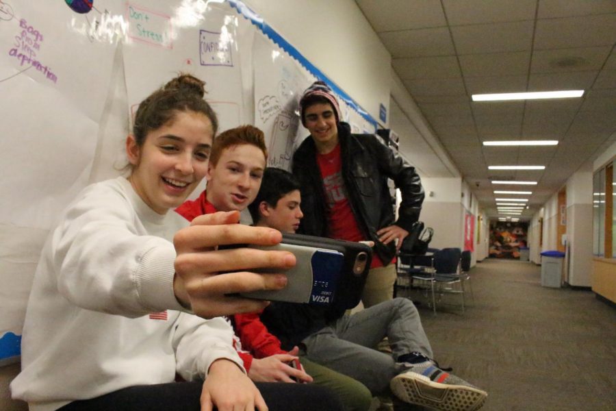 Sophomore Estelle Heltzer takes a selfie with Tomas Cattagio, Micah Derringer, and Max Antoniou to send to he Snapchat streaks.