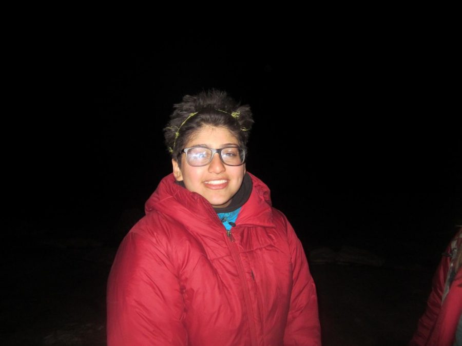 Olivia Garg wears a grass headband while hiking through the Utah Desert at night on her school orientation trip.