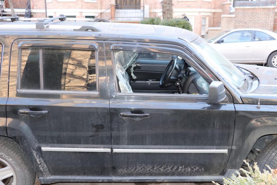 A car with a shattered window parked near Parker after robbery.