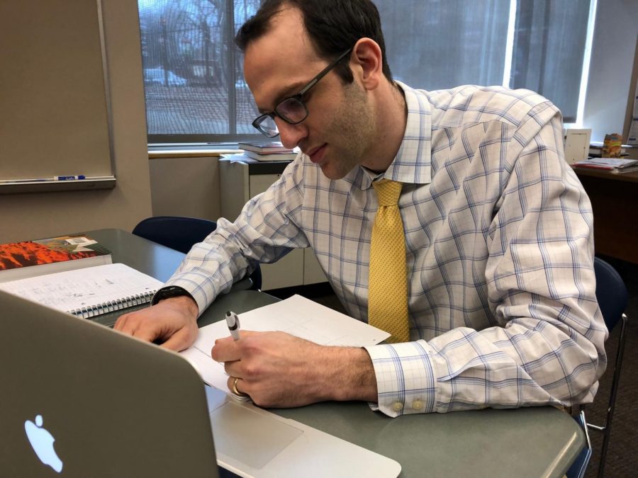 Upper School Math teacher Ethan Levine grades a student’s math test in his free time. 