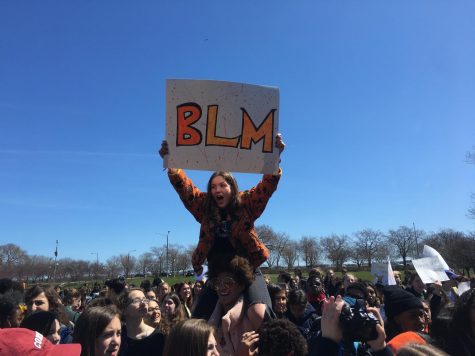Freshman Nathalie San Fratello holds Black Lives Matter sign while protesting at the Chicago Student Walkout on April 20.  