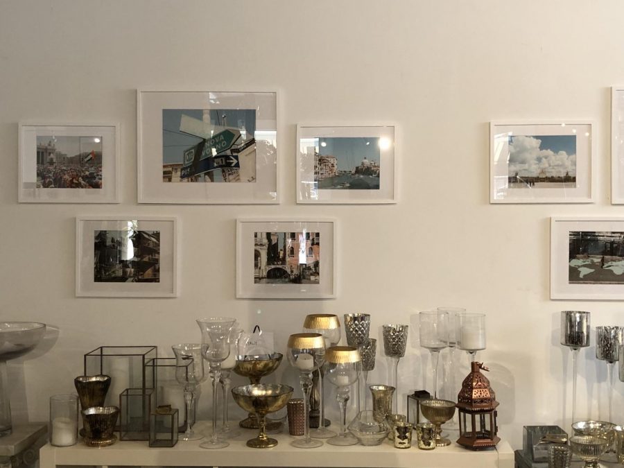 A grouping of urban photographs from Italy sit on a wall of the Kathryn Avila ‘08 Crossed Countries exhibit.