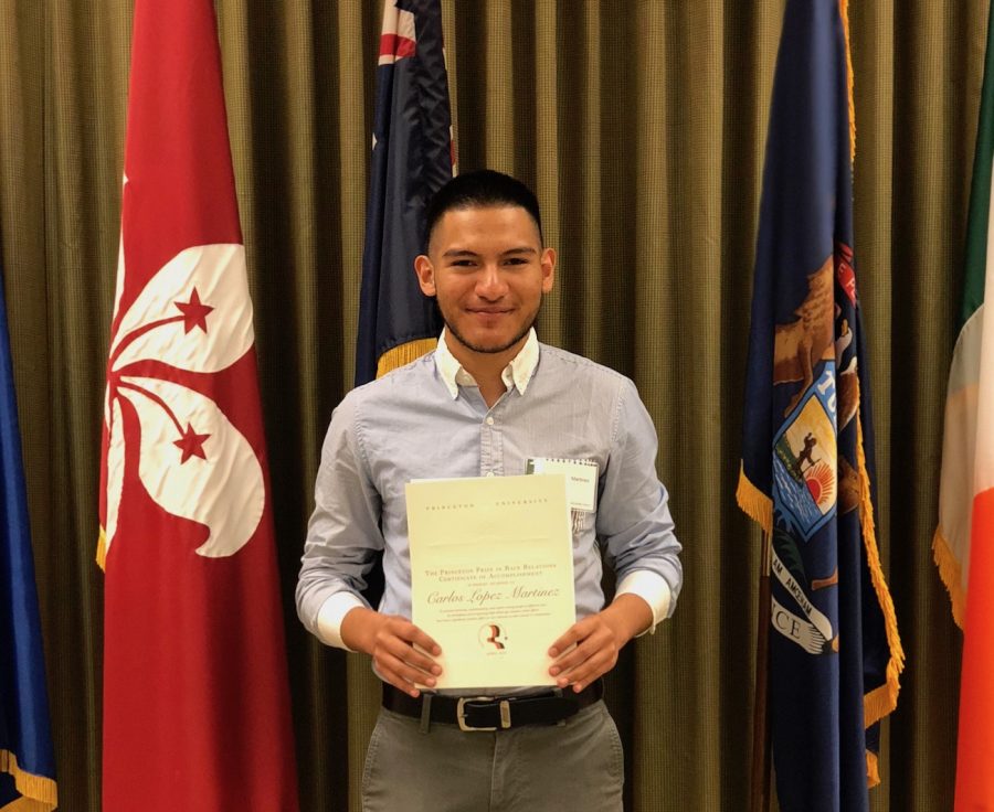 Senior Carlos Lopez holds his Certificate of Accomplishment by the Princeton Prize in Race Relations.