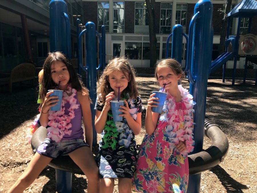 Three girls pause from the fun at Parker’s playground for a cool drink.
