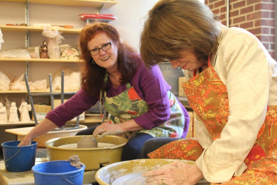 Cole (left) and Susan Weingartner illustrate the joy and concentration needed to create a thrown pot using a potter’s wheel. Photo courtesy of Francis W. Parker School.