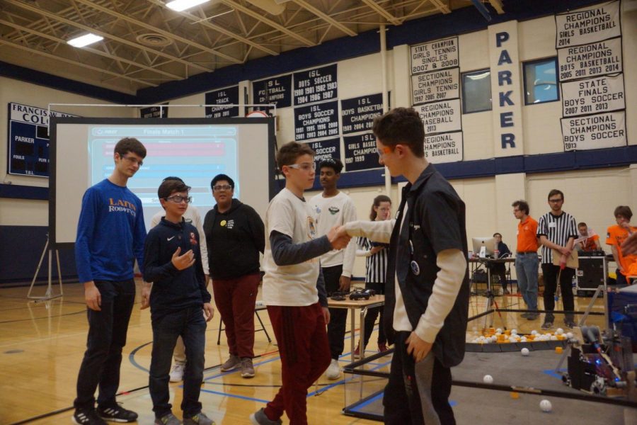 Freshman Ryder Selikow shakes hands with his Latin counterpart before the first-place match of the Chicago North League Championship.