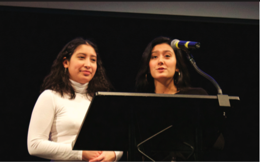 Juniors Gigi Lopez and Anjali Chandel, heads of Students Affirming Gender Equality (SAGE), speak at Gender Week’s closing ceremony.