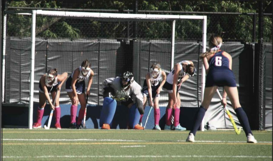 Five players from the Varsity Girls Fieldhockey team defend the goal during their Homecoming game versus Latin.