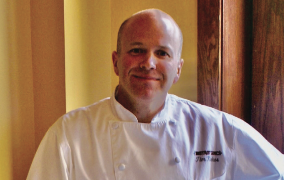 Executive Chef Tim Kirker poses in his chef garb.