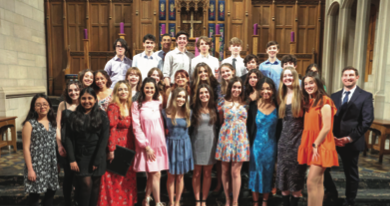 Grape Jam poses in front of the altar at Fourth Presbyterian Church. 