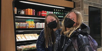 Wrubel prepares her expert tastebuds in front of the drink cooler with Caroline Skok. 