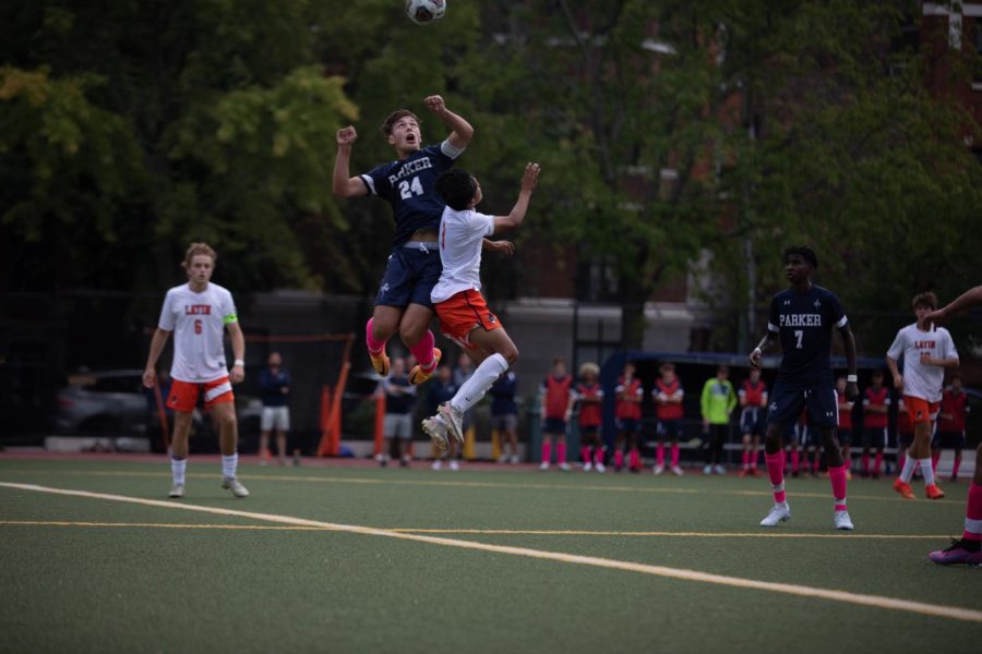 Senior Gray Joseph jumps to reach the soccer ball.