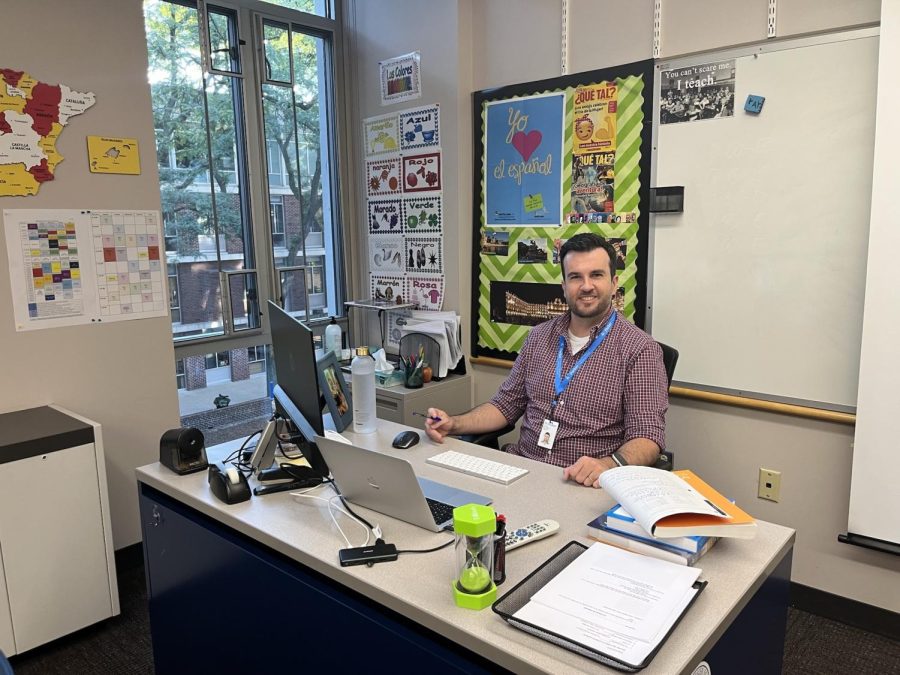 New Upper School Spanish Teacher Antonio Amo Quintenila poses at
his desk.