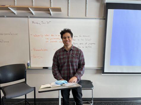English teacher Lang Kanaï poses for a photo in his classroom.