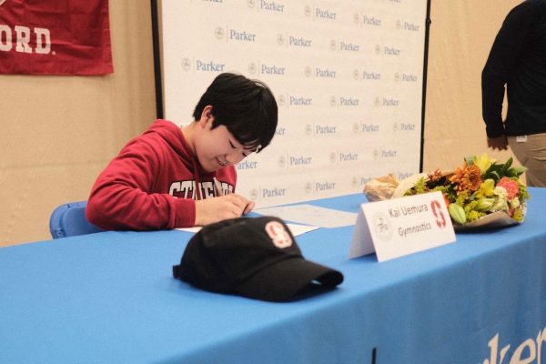 Kai Uemura signs commitment to Stanford University for gymnastics at signing day ceremony.
