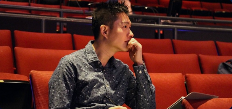 Caleb Goh oversees his students on stage