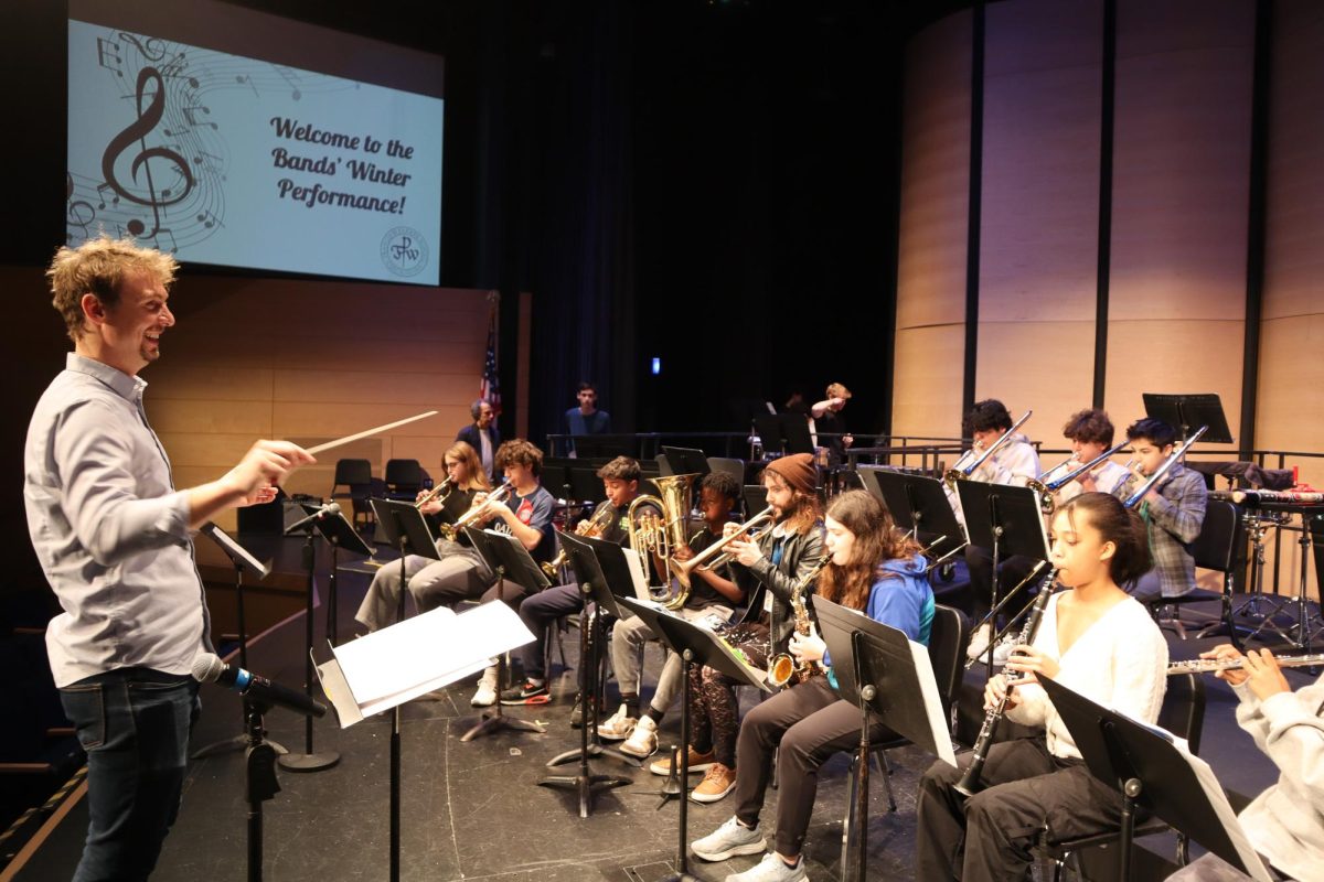Alec Synakowski conducting the Advance Wind Ensemble.