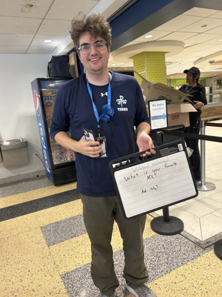 Luke Drake holds "White Board Wednesday" whiteboard