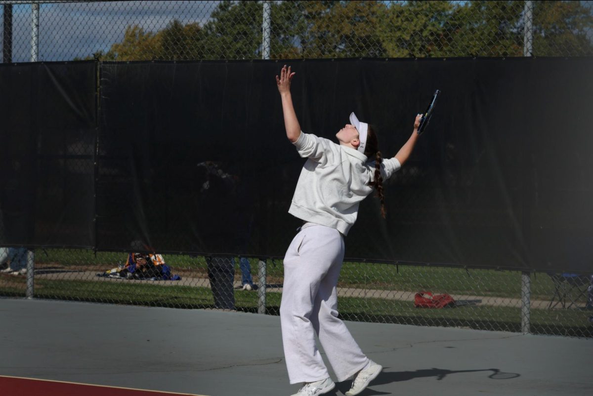 Graysen Pendry serving at tennis states. 