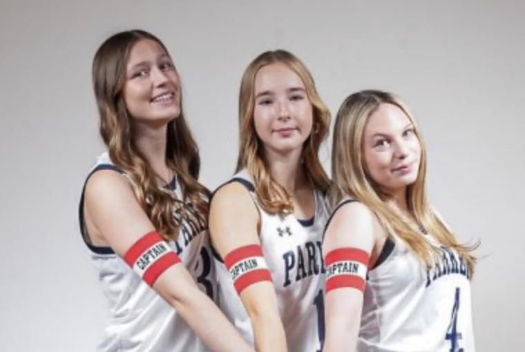 Girls basketball captains Jojo Husbeck, Kiley Moss, and Miriam Johnson pose on media day 