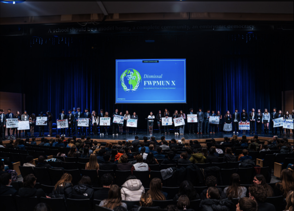 FWPMUN X head chairs line up on stage before delegates begin debate