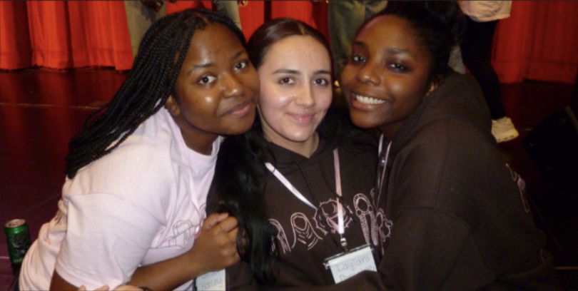 Grace Hatley, Laylani Pomales, and Ewuraesi Korankye smile at the symposium. 